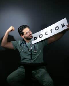 portrait of a doctor celebrating in scrubs