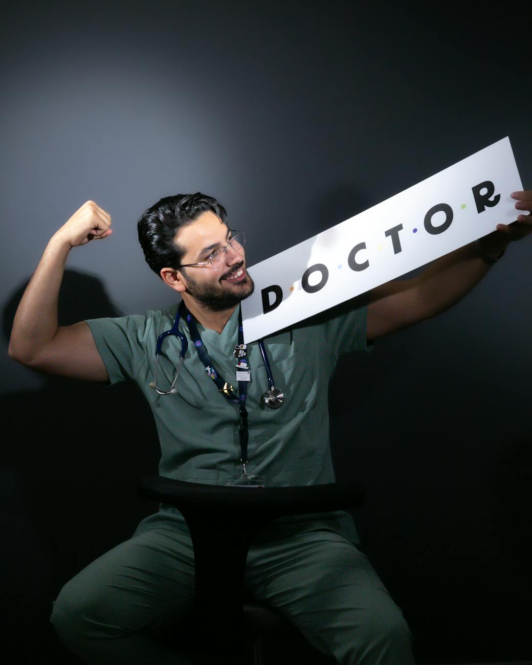 portrait of a doctor celebrating in scrubs